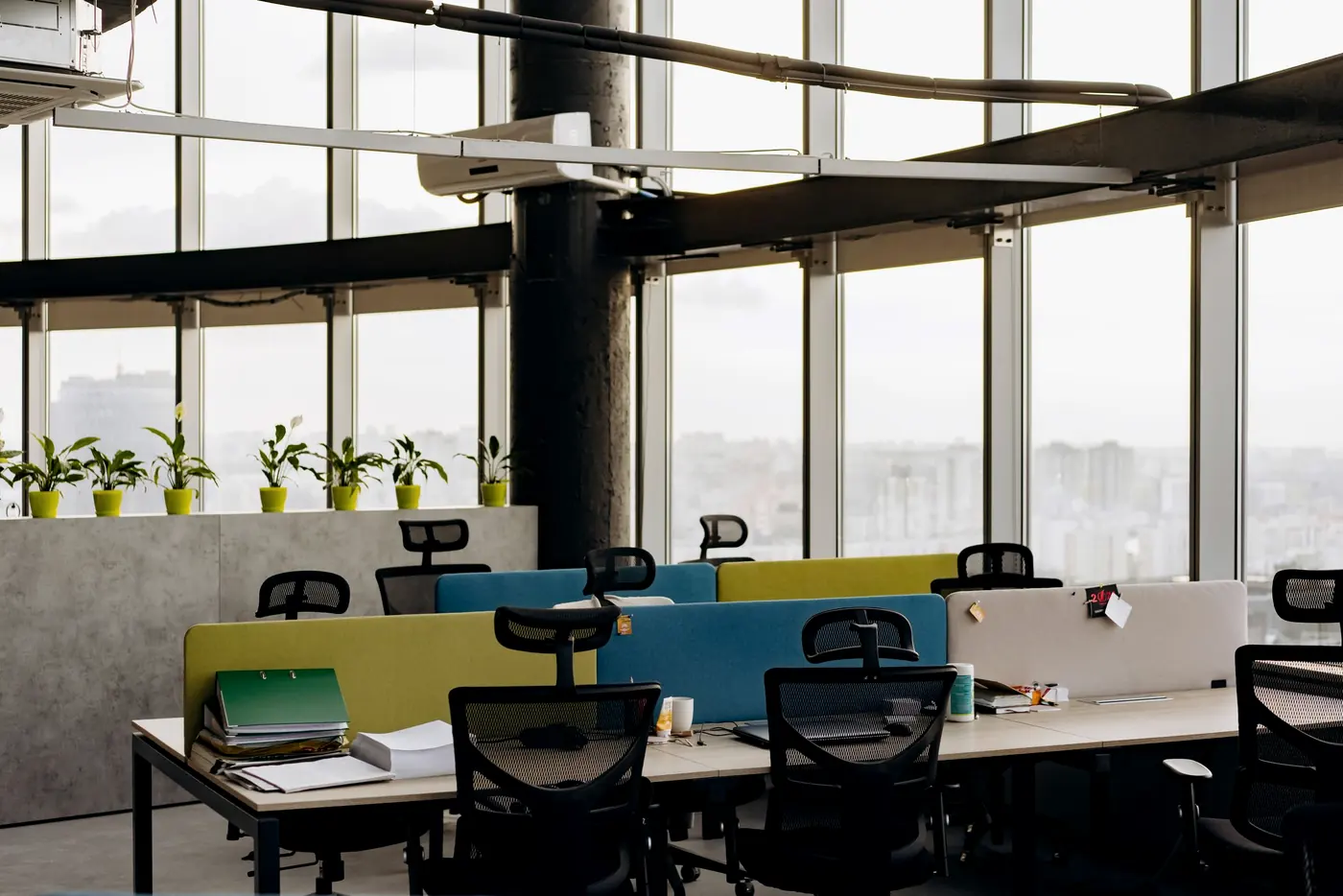 Escritório corporativo com estações de trabalho e vista para a cidade